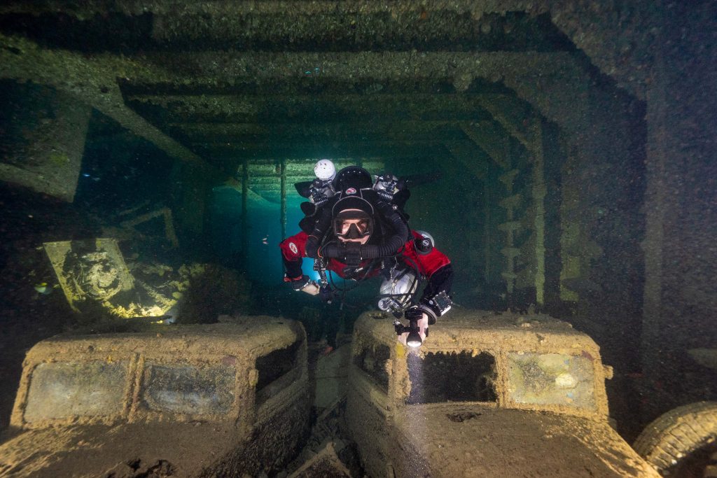 Inside of the SS Thistlegorm shipwreck with scuba diver. Photo by Kees Beemster Leverenz.