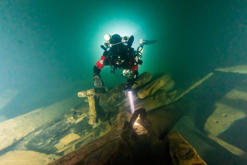 Diver swimming along the remains of the warship, the Mars. 