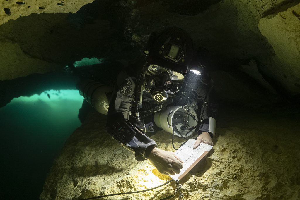 Alex K.S. Fraser records flow rates across a cave passageway at Xel Ha during Under the Jungle's annual Science Week. 