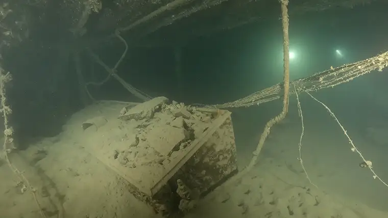 The pantry and the saloon area covered with silt after more than a century underwater.