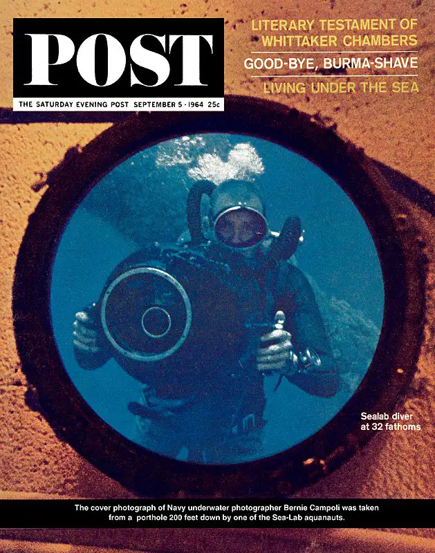 This cover photograph of photographer Bernie Campoli was taken from inside Sealab I by aquanaut Bob Barth