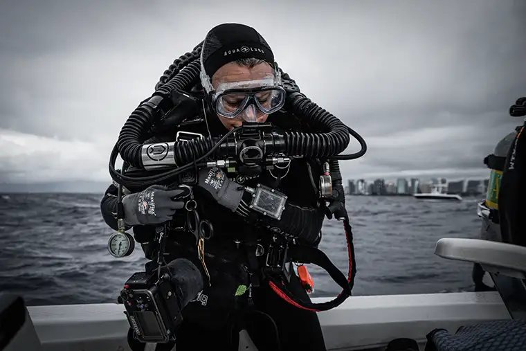 Dr. Rowley entering the water for research on octocoral flow dynamics